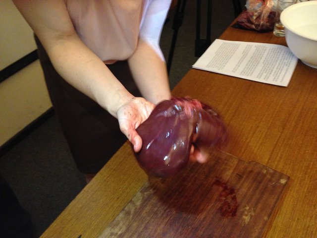 A Woman Holding a Liver